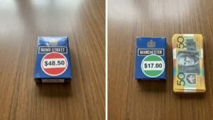 Comparison of Bond Street cigarettes price $48.50 vs Manchester cigarettes $17.00 with Australian banknotes saving money
